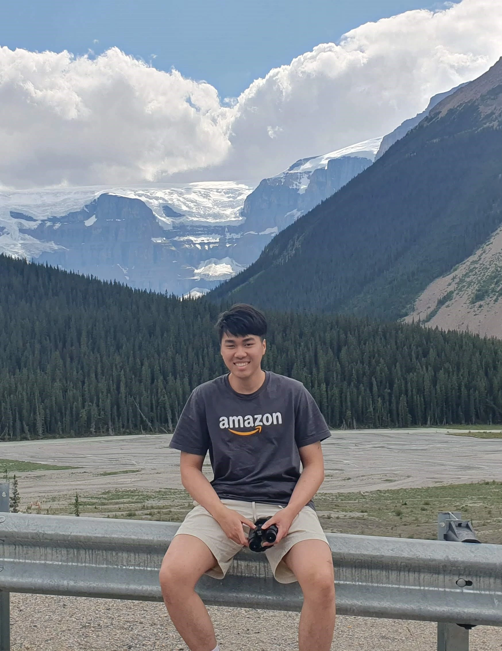 A guy (me) posing with a an Amazon t-shirt with the Columbia Icefield in the background.